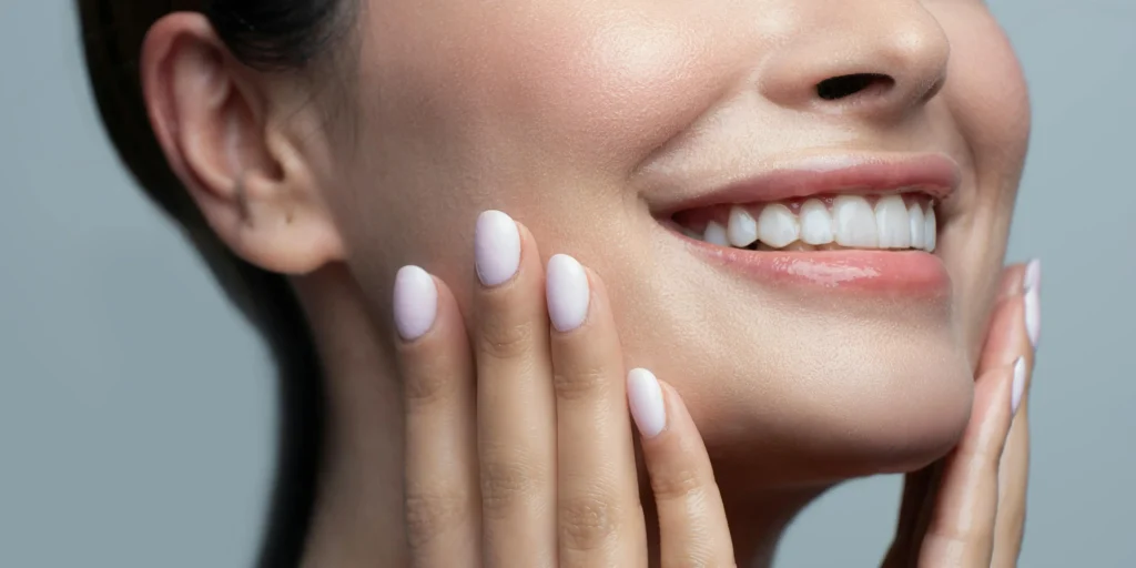 woman smiling showing healthy teeth after full mouth dental implant treatment